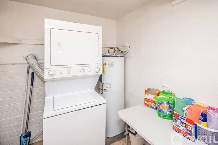 A white washing machine and dryer in a small laundry room.