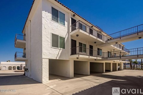 A white building with a balcony and a sign that says "available".