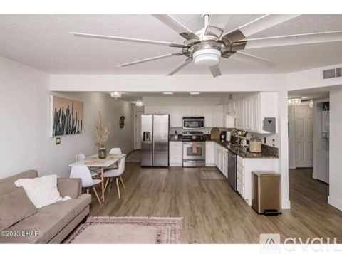 A modern kitchen with a dining table and chairs.