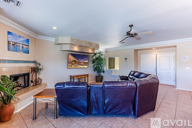 A living room with a blue sofa and a fireplace.