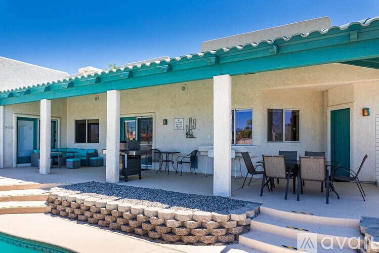 A house with a pool in front of it.