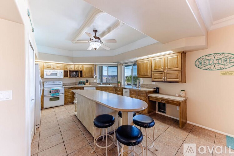 A kitchen with a table and chairs in the middle of the room.