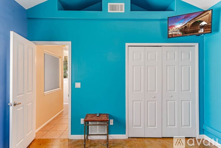 A room with blue walls and a white door.