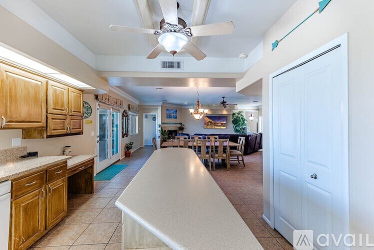 A kitchen with wooden cabinets and a white island.