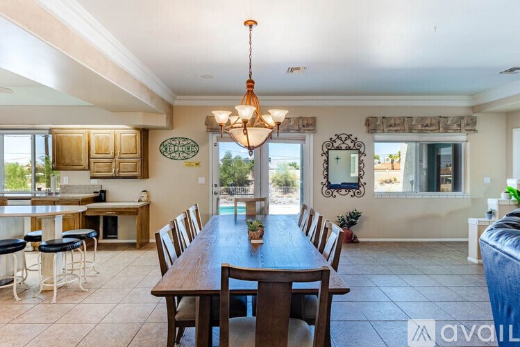A dining room with a wooden table and chairs.