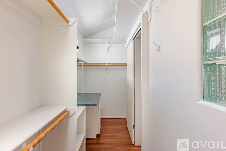 A long hallway with a green table and white walls.