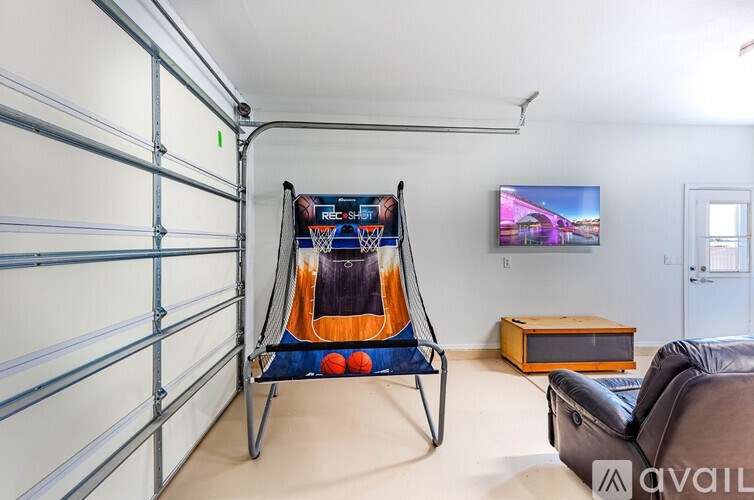 A room with a recliner chair and a television on the wall.