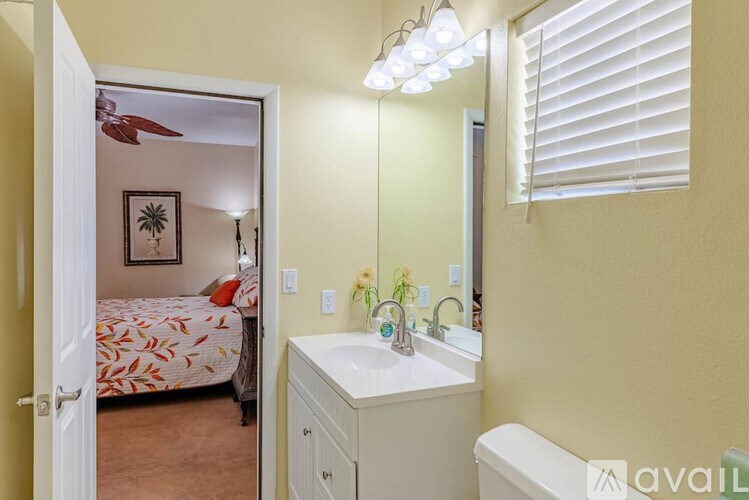 A bathroom with a bedroom doorway leading to a bedroom.