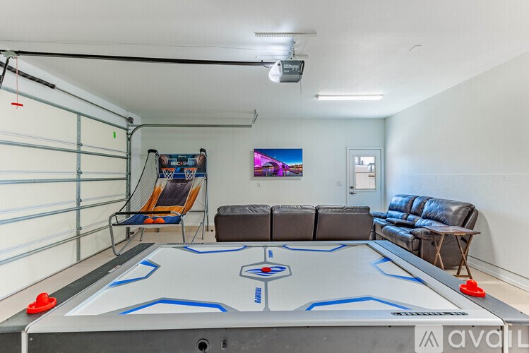 A room with a pool table and a couch.