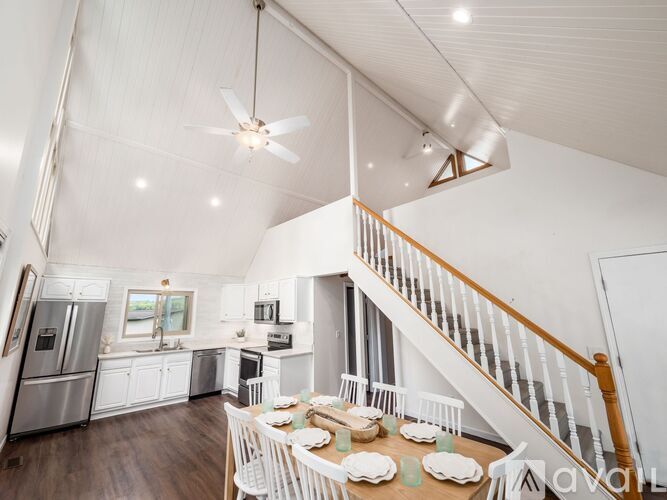 A kitchen with a dining table set for six.