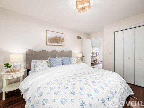 A bedroom with a large bed and a chandelier.