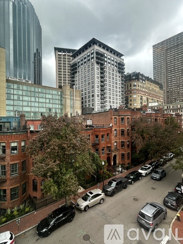 A city street with cars and buildings.