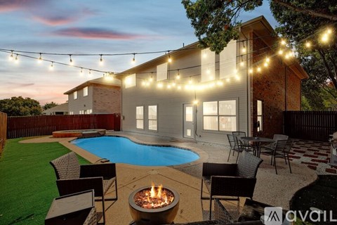 A house with a pool and a fire pit in the backyard.
