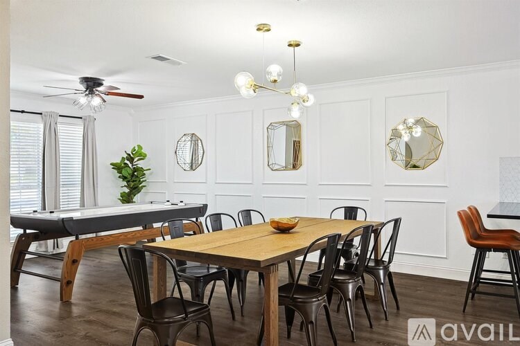 A dining room with a wooden table and chairs.