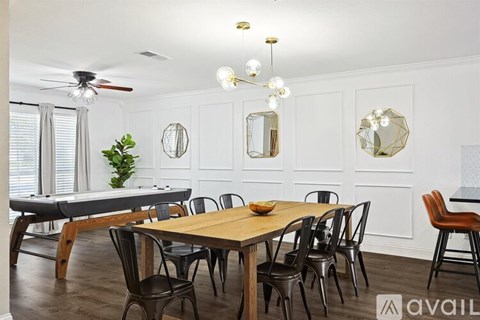 A dining room with a wooden table and chairs.