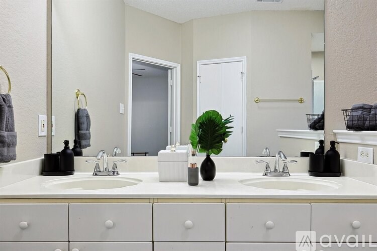 A bathroom with two sinks and a mirror.