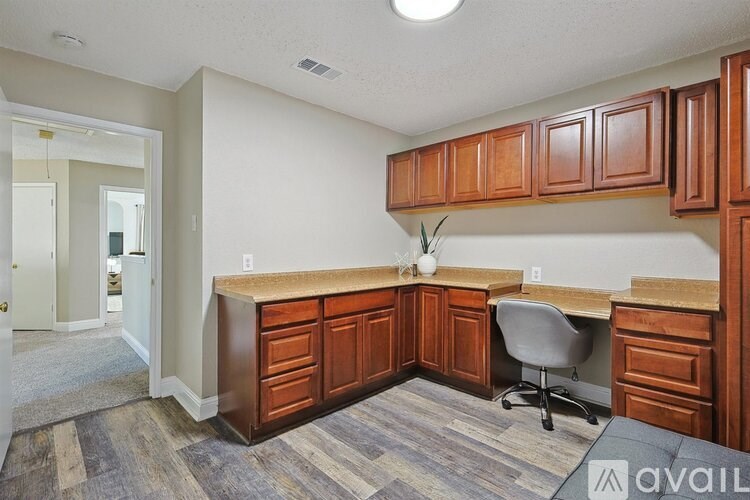 A room with a desk and a chair.