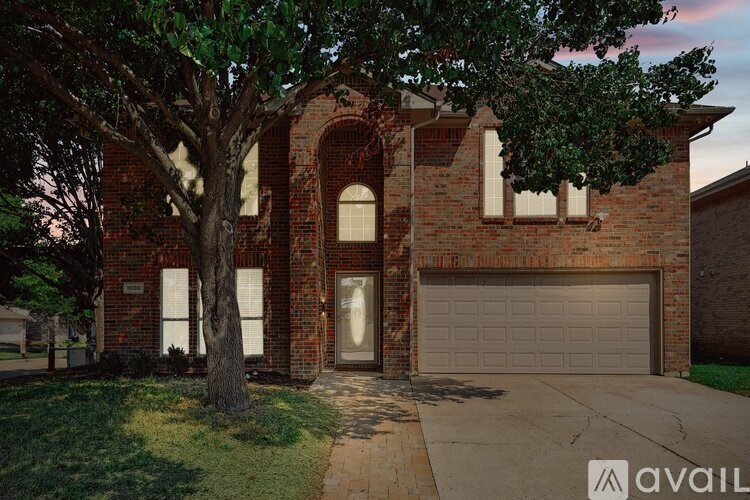 A house with a tree in front of it.