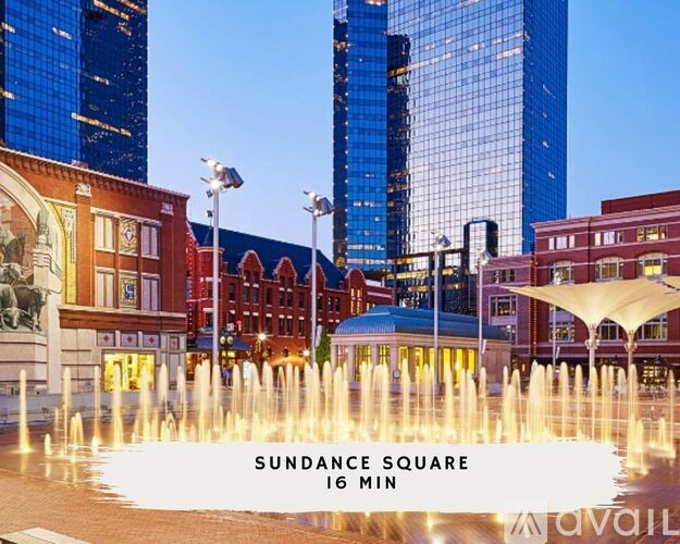 A fountain in the middle of a plaza with the text "Sundance Square 16 min" on it.