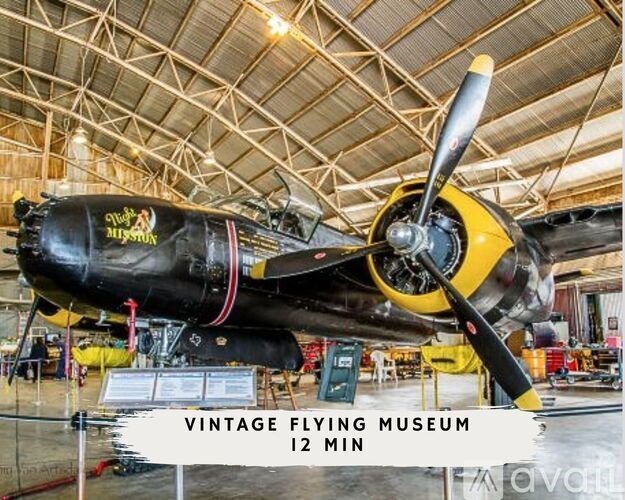 A black and yellow vintage airplane is on display at the Vintage Flying Museum.
