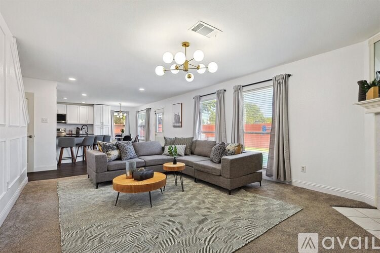 A living room with a grey couch and a wooden coffee table.