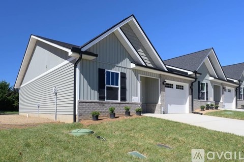 A modern house with a grey exterior and a white garage door.