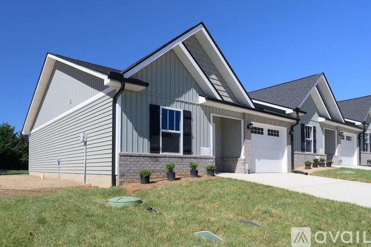 A modern house with a grey exterior and a white garage door.