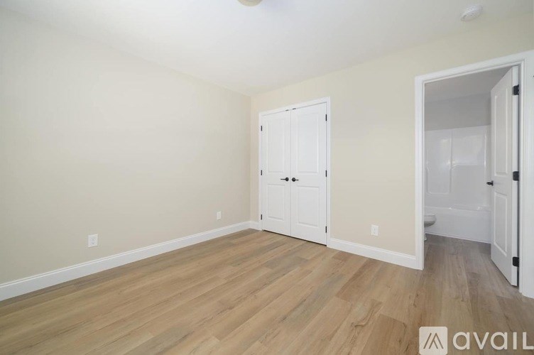 A room with a wooden floor and white walls.
