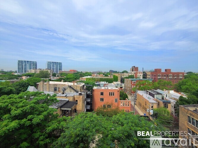 A cityscape with buildings of various sizes and a clear sky.