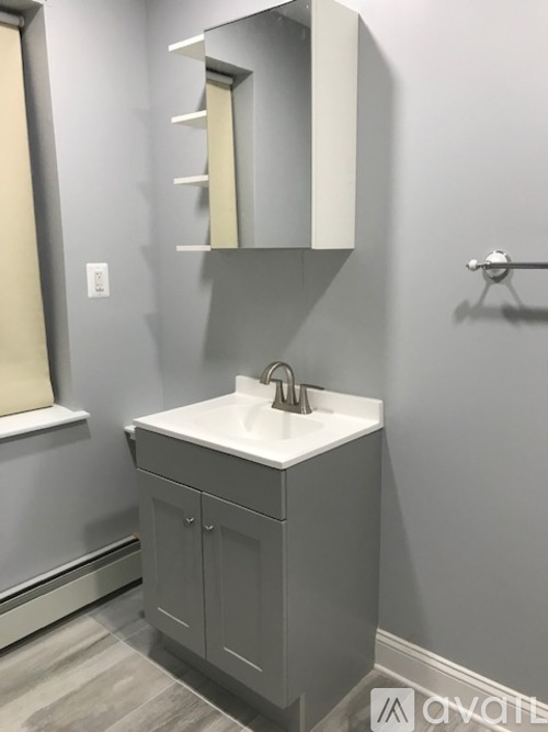 A bathroom with a sink and a mirror.