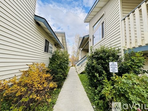 A residential area with a sign that says "No Parking" and a sidewalk.