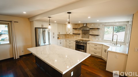 A kitchen with a large island in the middle.