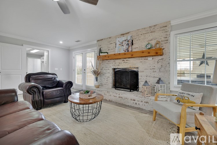 A living room with a fireplace and a chair.