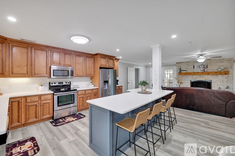 A kitchen with wooden cabinets and a white island.