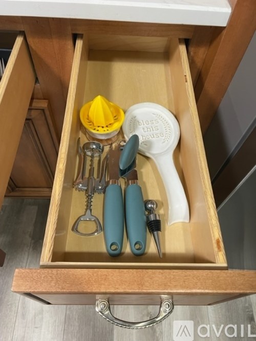 A drawer with a yellow object and a blue and white object.