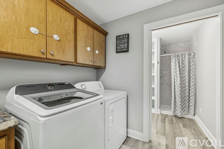 A red oven mitt is in a drawer with knives.