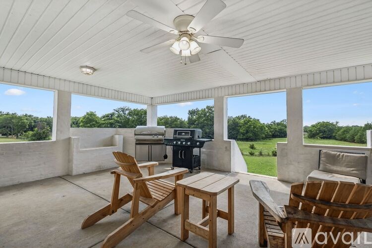 A set of colorful kitchen utensils are in a white ceramic container.