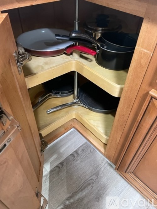 A kitchen drawer with pots and pans.