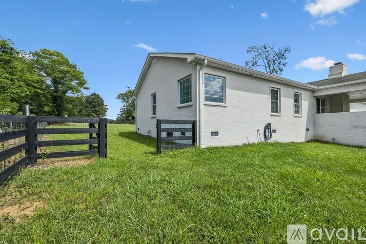 A kitchen with white cabinets and a wooden counter.