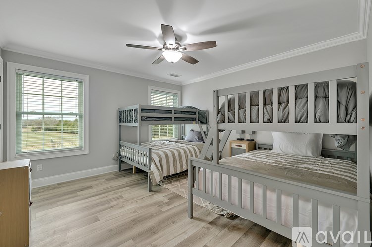 A bedroom with a bunk bed and a single bed.