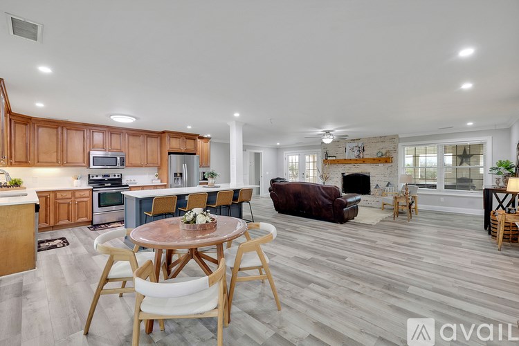 A modern kitchen with wooden cabinets and a dining table set for four.