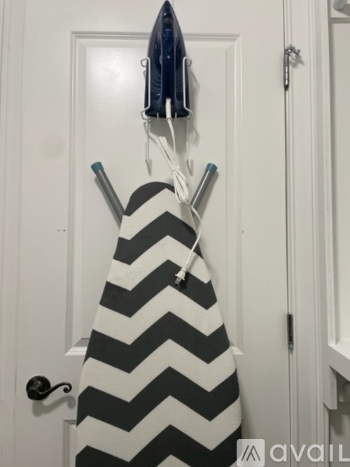 A black and white striped towel hanging on a towel rack.
