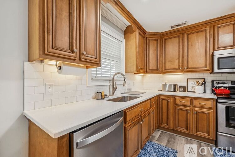 A living room with a fireplace and a tv on the wall.