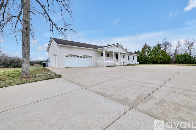 A two-story house with a garage is available for sale.