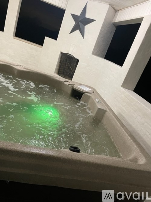 A hot tub with a green light in the middle.