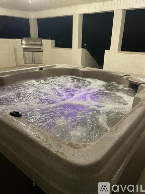 A hot tub with purple lights in the middle of it.