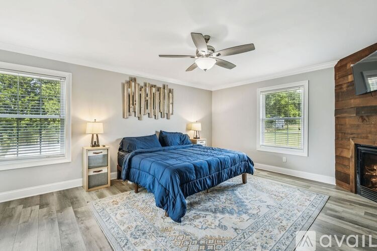A modern dining room with a round wooden table and chairs.