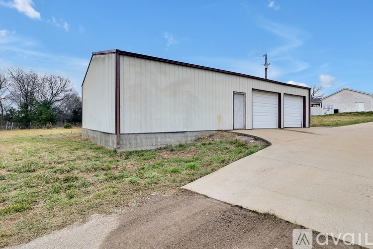 A large, empty building with a concrete walkway in front.