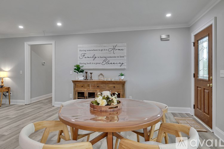 A dining room with a wooden table and chairs.