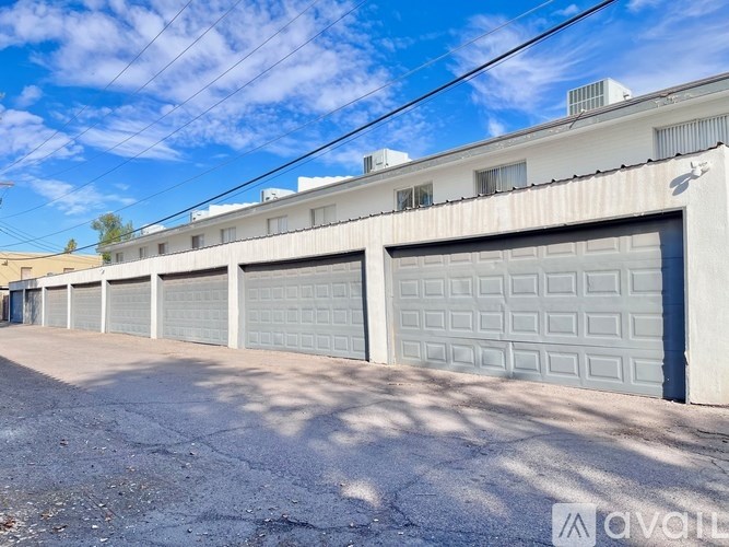 A row of garage doors in front of a building.